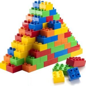 Colorful brick pyramid with scattered blocks on white background